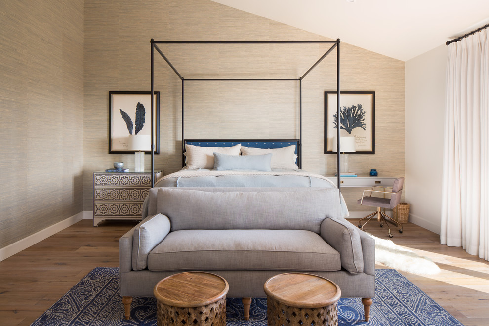 This is an example of a mediterranean grey and brown bedroom in Santa Barbara with beige walls, medium hardwood flooring and brown floors.