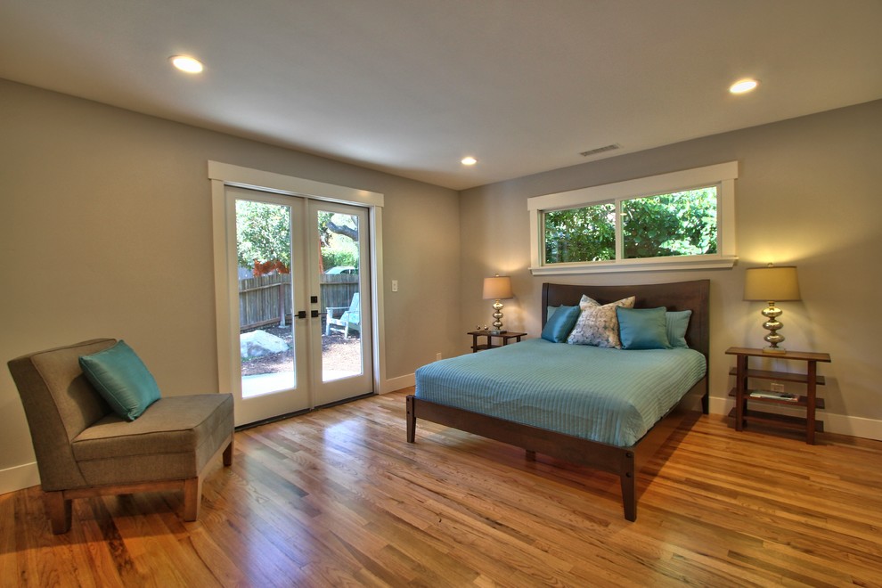 Mid-sized transitional master medium tone wood floor and brown floor bedroom photo in Other with gray walls