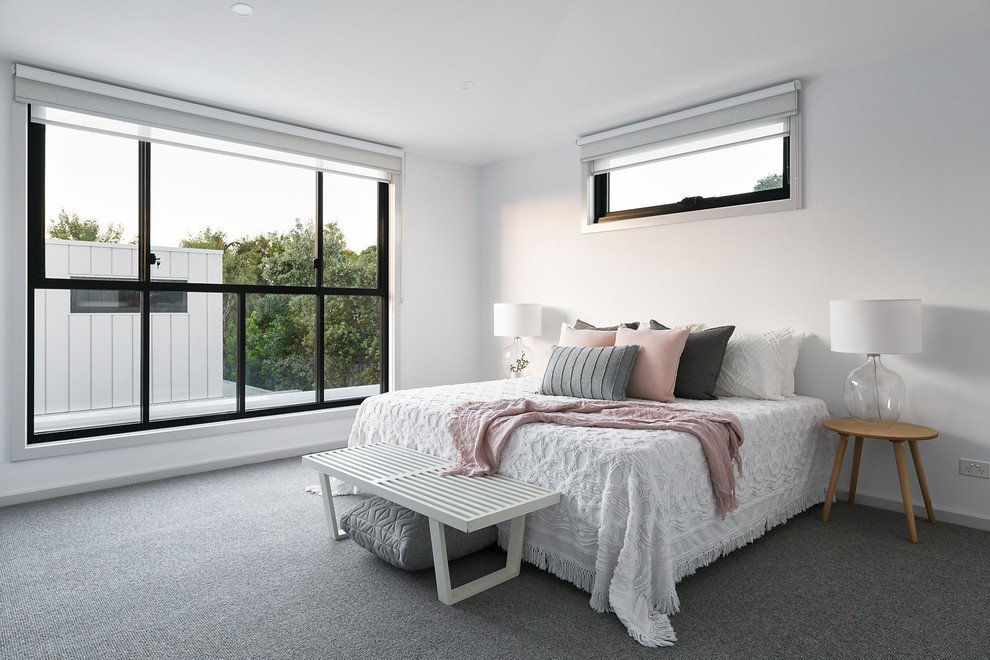 Photo of a contemporary bedroom in Melbourne with white walls, carpet and grey floors.