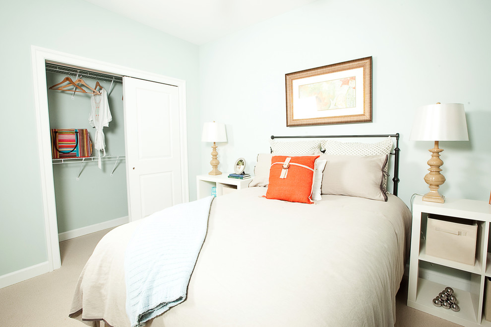 Immagine di una camera degli ospiti american style con pareti blu, moquette e nessun camino