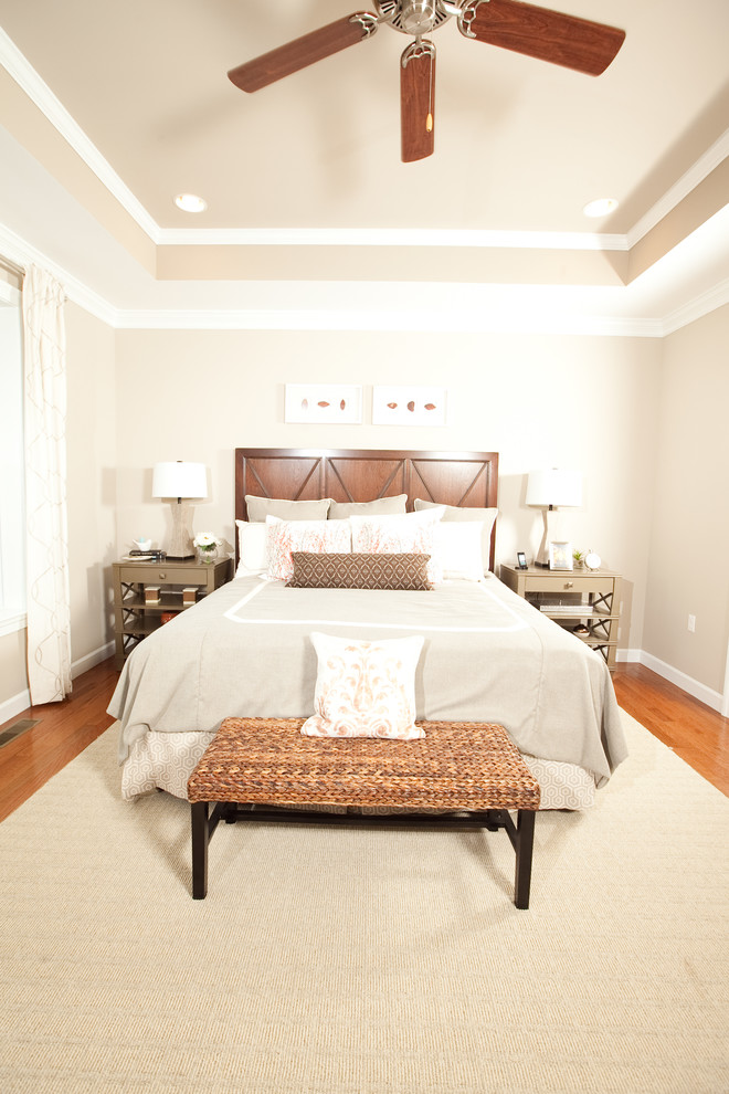 This is an example of a large classic master bedroom in DC Metro with beige walls, medium hardwood flooring and no fireplace.