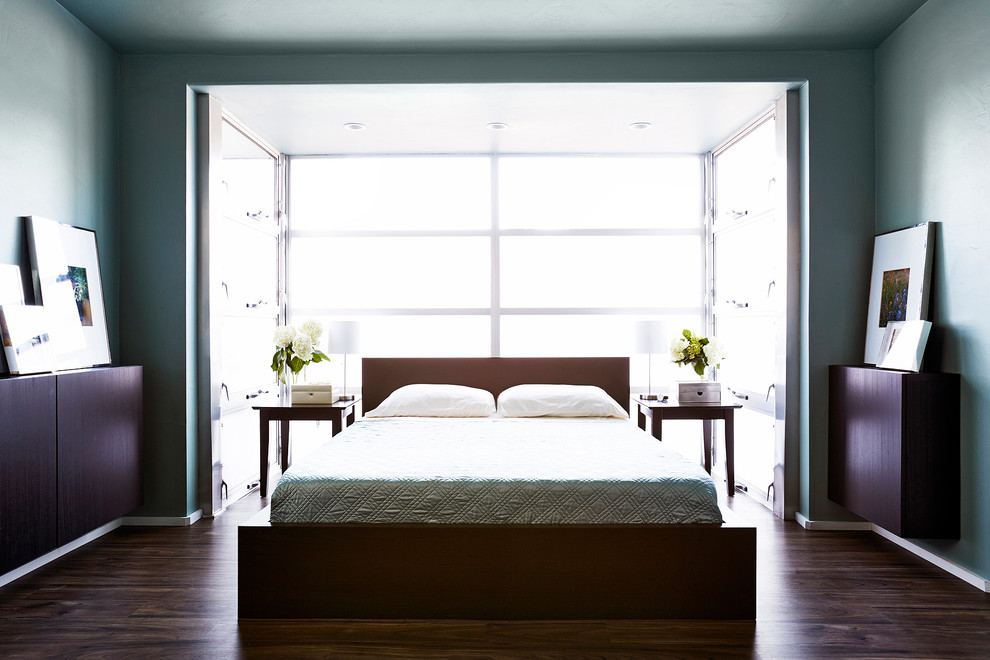 На фото: хозяйская спальня в современном стиле с зелеными стенами и темным паркетным полом