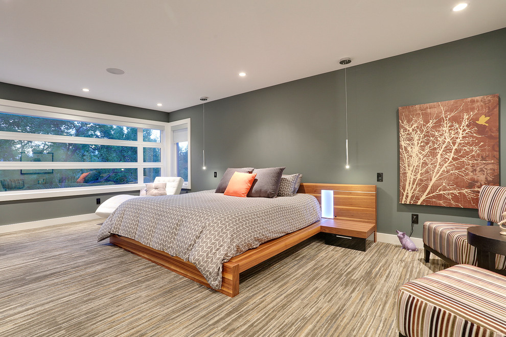 This is an example of a contemporary master bedroom in Calgary with grey walls and carpet.