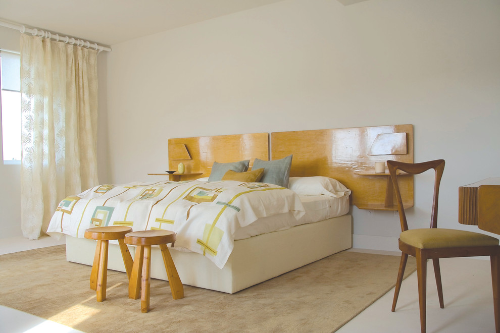 Inspiration for a modern bedroom remodel in Miami with beige walls