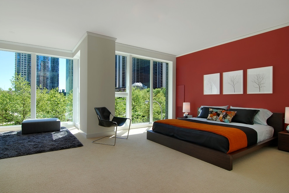 Modern bedroom in Chicago with red walls and carpet.
