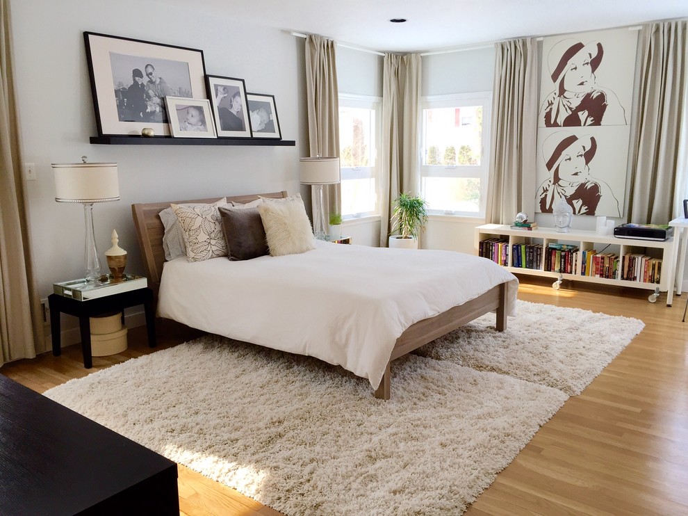 Inspiration for a large modern master light wood floor bedroom remodel in New York with white walls