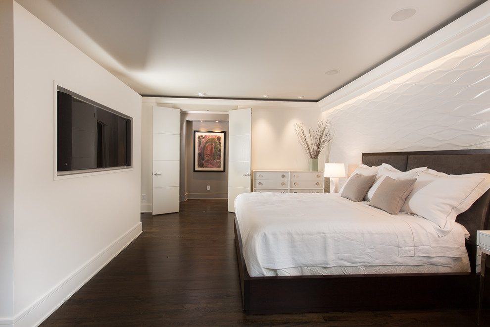 Contemporary bedroom in Atlanta with white walls and dark hardwood flooring.