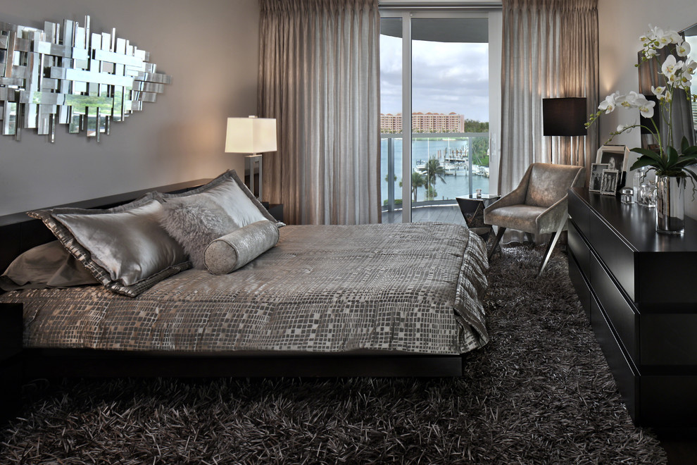 Photo of a medium sized modern master and grey and silver bedroom in Miami with beige walls, carpet and brown floors.