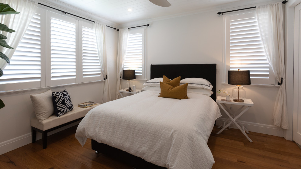Inspiration for a medium sized country bedroom in Wollongong with white walls, medium hardwood flooring and a timber clad ceiling.