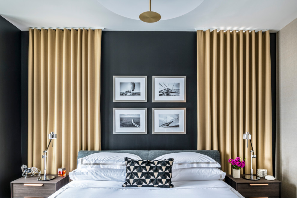 This is an example of a small modern master bedroom in Boston with black walls, light hardwood flooring and grey floors.