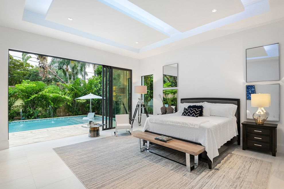 マイアミにある広いコンテンポラリースタイルのおしゃれな主寝室 (白い壁、磁器タイルの床、白い床)