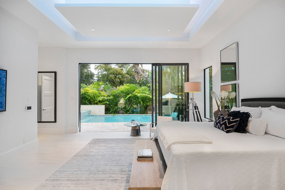 Inspiration for a large contemporary master bedroom in Miami with white walls, porcelain flooring and white floors.