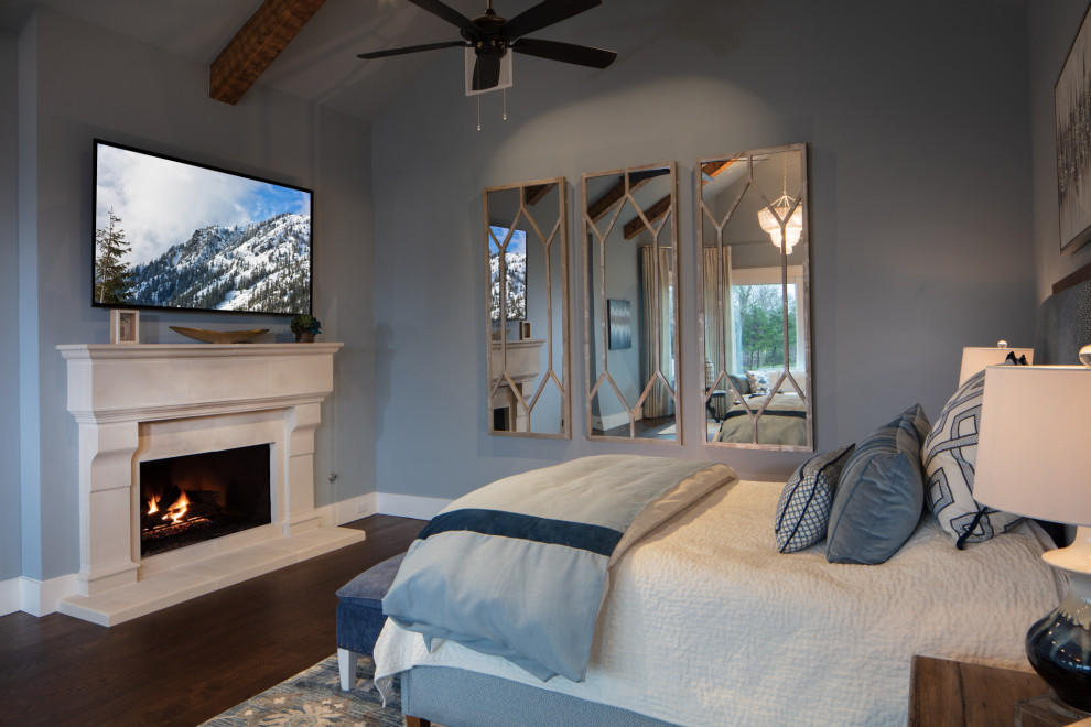 Inspiration for a large country master medium tone wood floor and brown floor bedroom remodel in Dallas with blue walls, a standard fireplace and a concrete fireplace