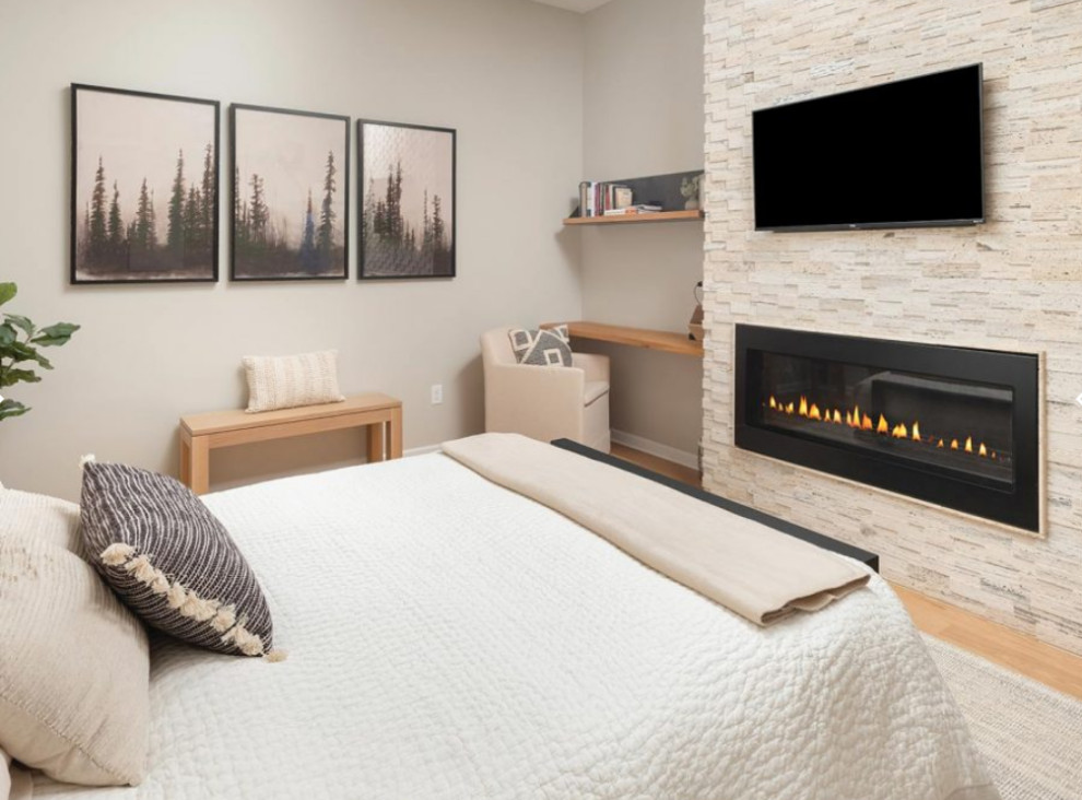 This is an example of a medium sized modern master bedroom in Other with grey walls, light hardwood flooring, a ribbon fireplace, a metal fireplace surround and beige floors.