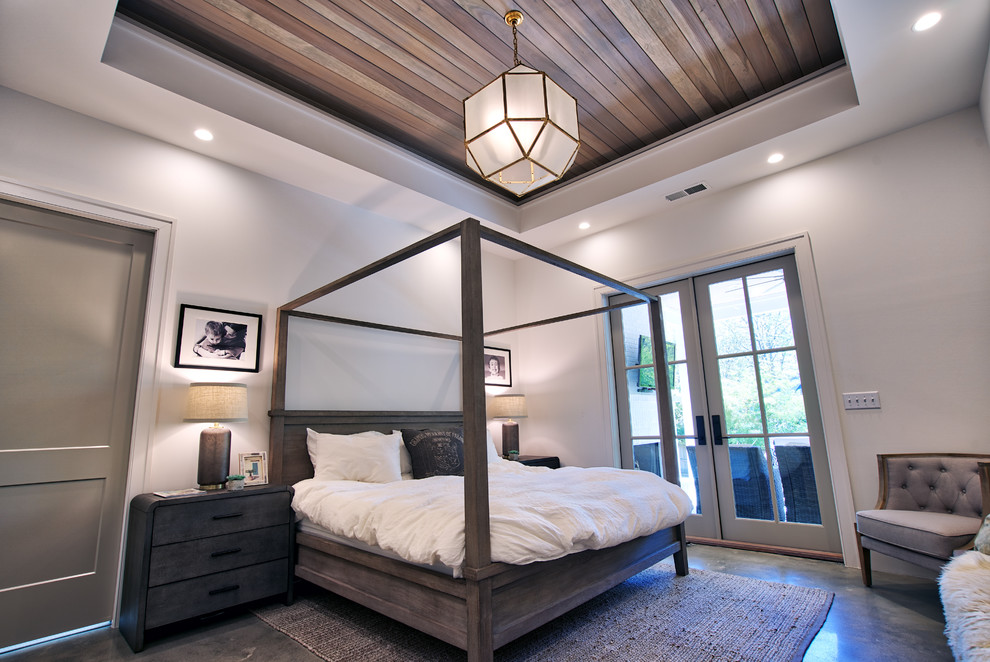 Inspiration for a medium sized modern master bedroom in Atlanta with white walls, concrete flooring, grey floors and feature lighting.