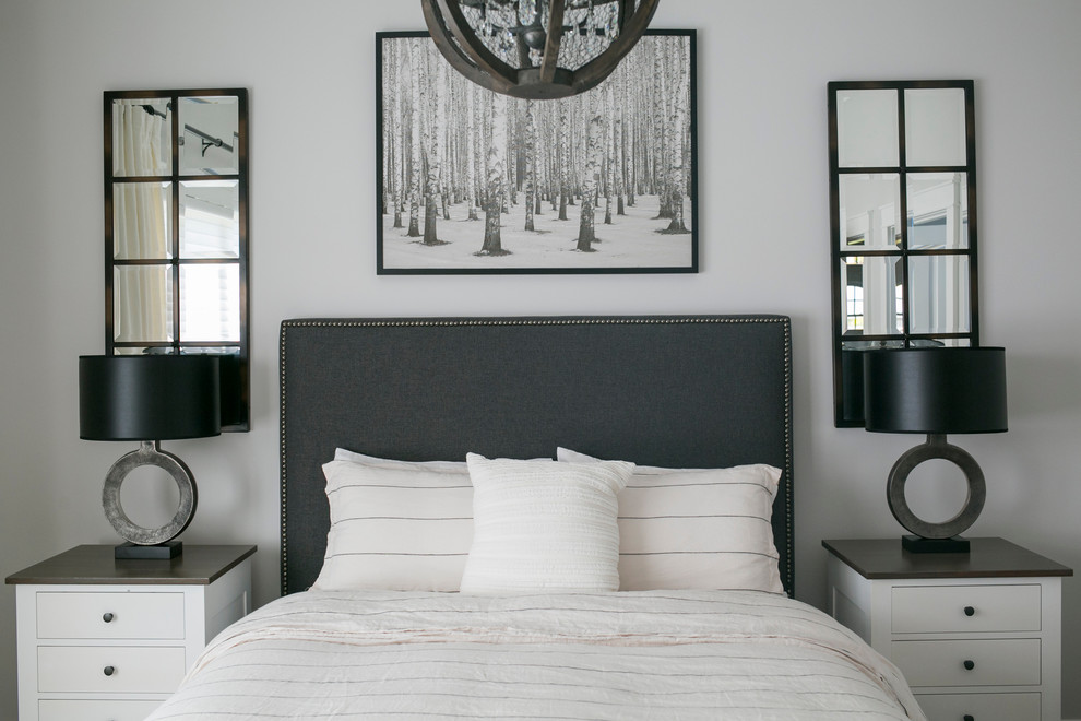 Inspiration for a mid-sized farmhouse master medium tone wood floor and brown floor bedroom remodel in Other with gray walls and no fireplace