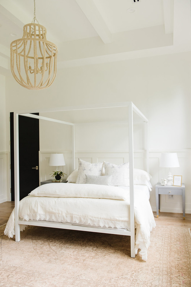 Design ideas for a large farmhouse guest bedroom in Salt Lake City with white walls and light hardwood flooring.