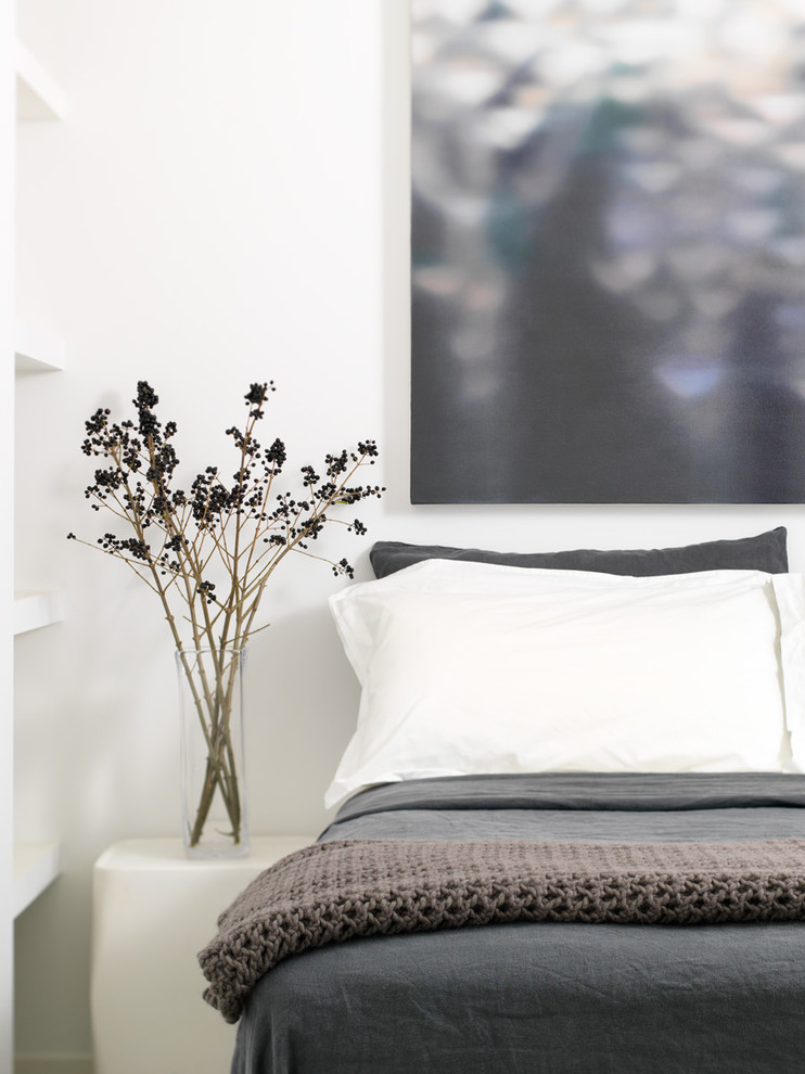 Small urban guest concrete floor and gray floor bedroom photo in Toronto with white walls