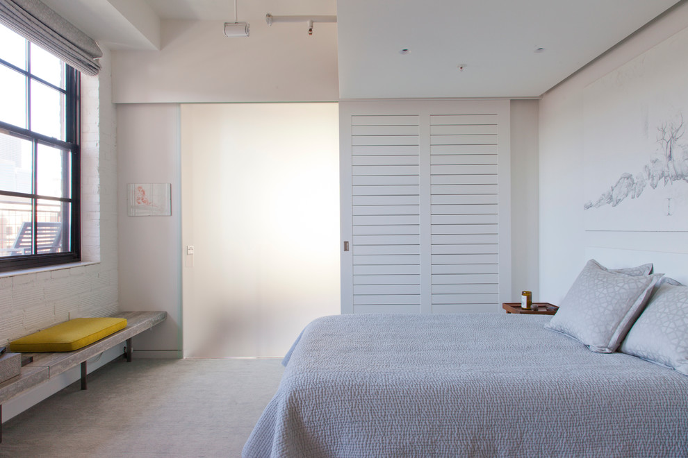 Ispirazione per una camera da letto design con pareti bianche, moquette e nessun camino