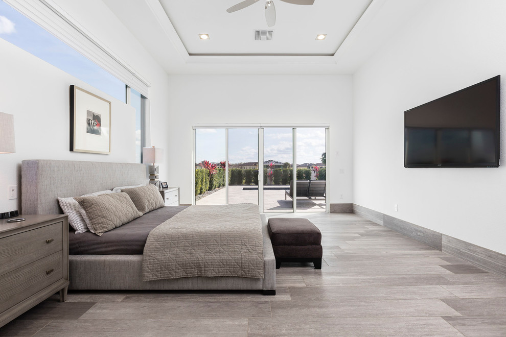 Medium sized contemporary guest bedroom in Orlando with white walls, porcelain flooring, no fireplace and grey floors.