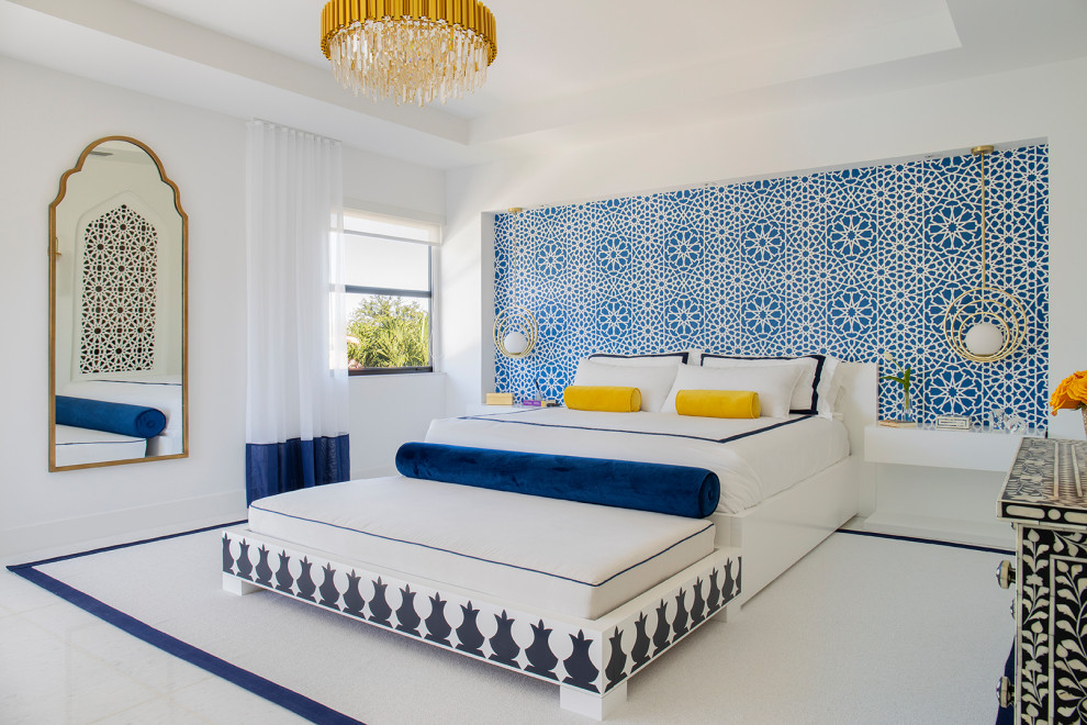 На фото: большая хозяйская спальня в стиле модернизм с белыми стенами, мраморным полом, подвесным камином, фасадом камина из дерева и белым полом с