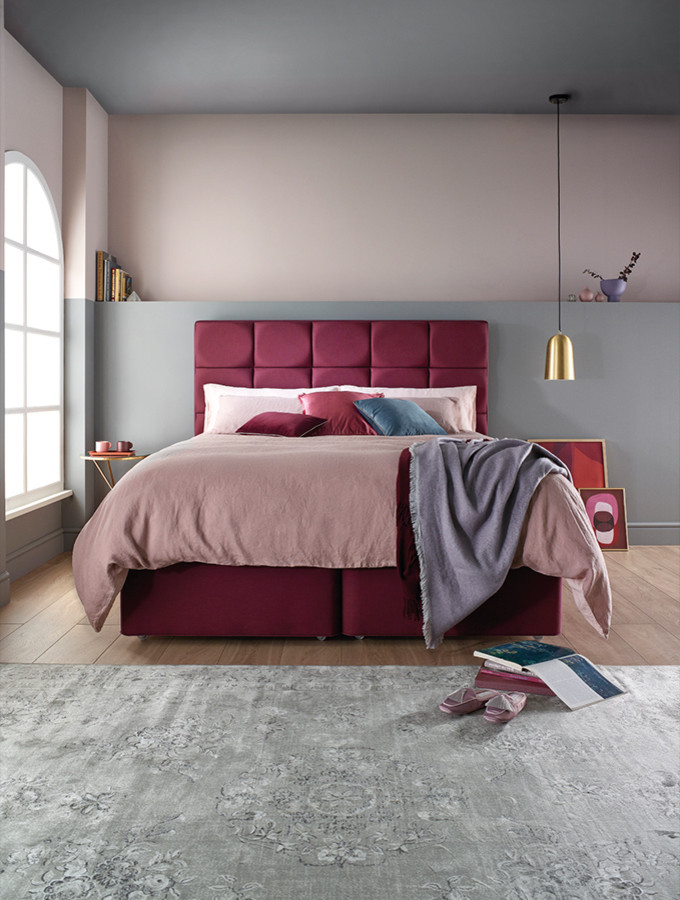 Inspiration for a medium sized modern guest and grey and pink bedroom in Manchester with pink walls, laminate floors and brown floors.