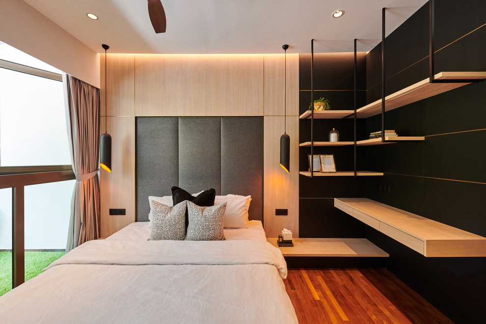 Contemporary grey and brown bedroom in Singapore with black walls, medium hardwood flooring and brown floors.