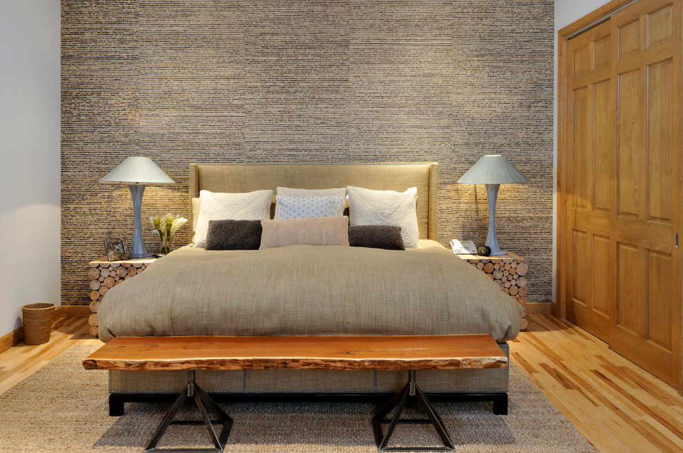 Rustic bedroom in Charlotte with multi-coloured walls and medium hardwood flooring.