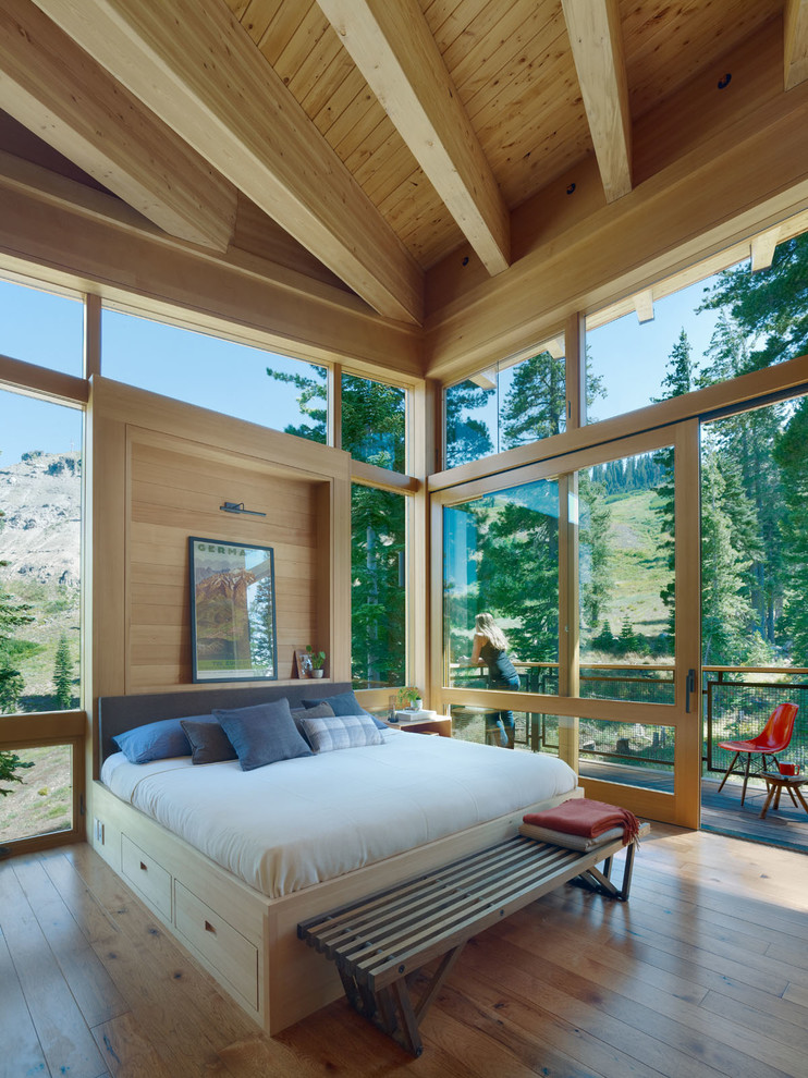 Photo of an expansive rustic master bedroom in San Francisco with light hardwood flooring.