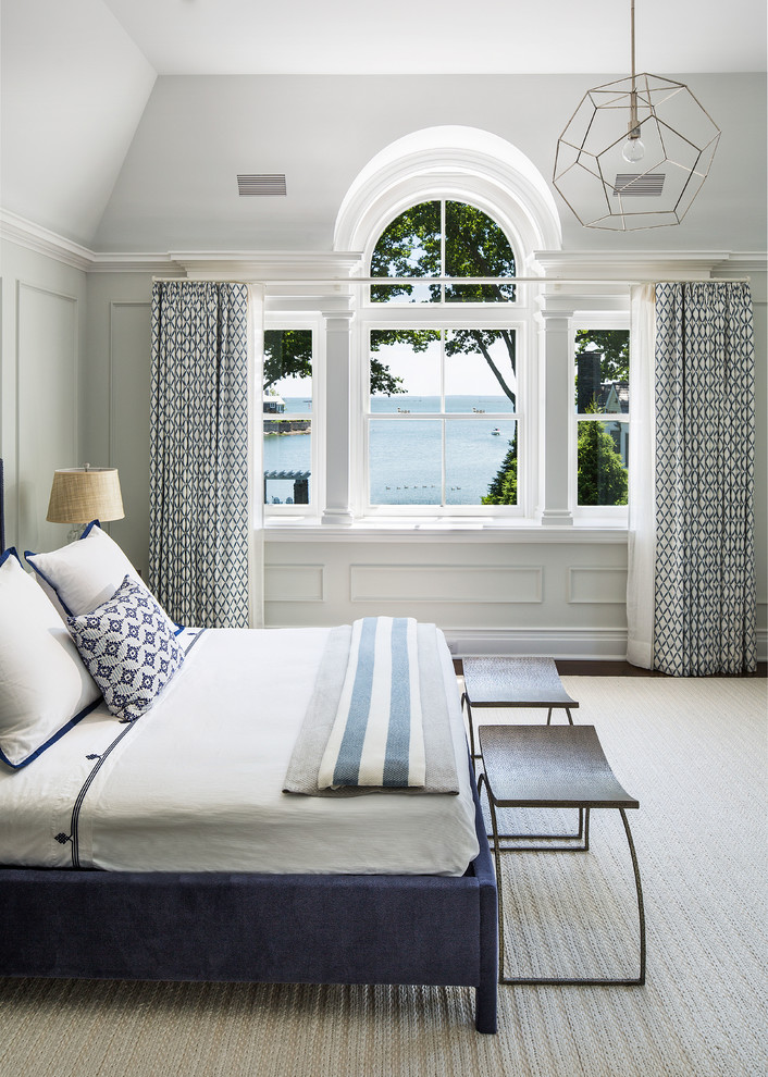 This is an example of a large coastal master and grey and brown bedroom in New York with white walls, dark hardwood flooring, no fireplace and brown floors.