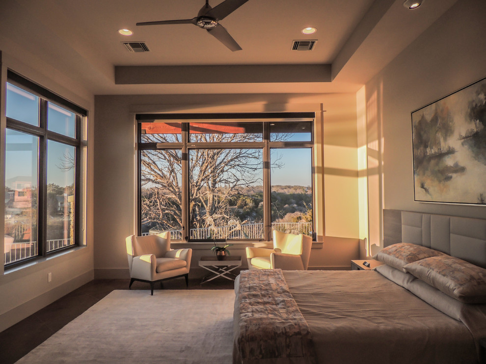 This is an example of a large contemporary master bedroom in Dallas with grey walls, concrete flooring and brown floors.
