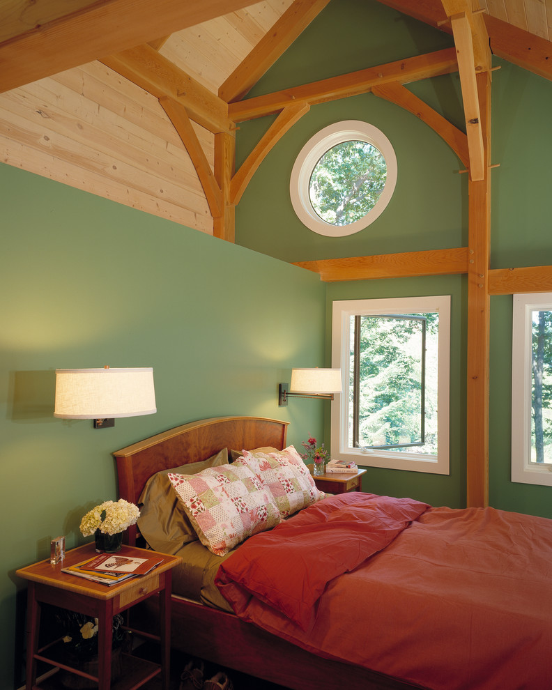 This is an example of a rustic master bedroom in Boston with green walls.
