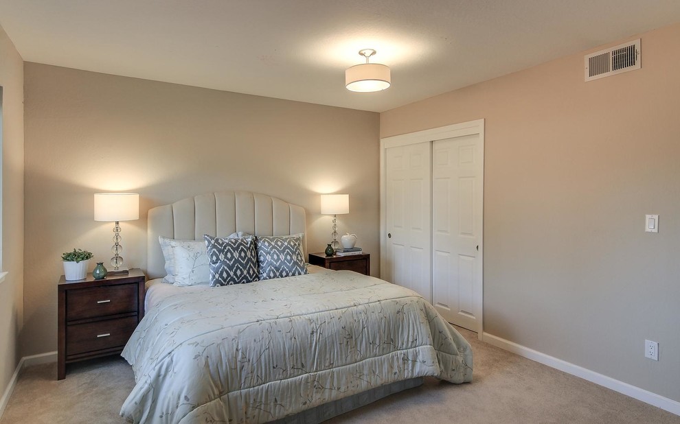 Photo of a medium sized traditional guest bedroom in Denver with beige walls and carpet.