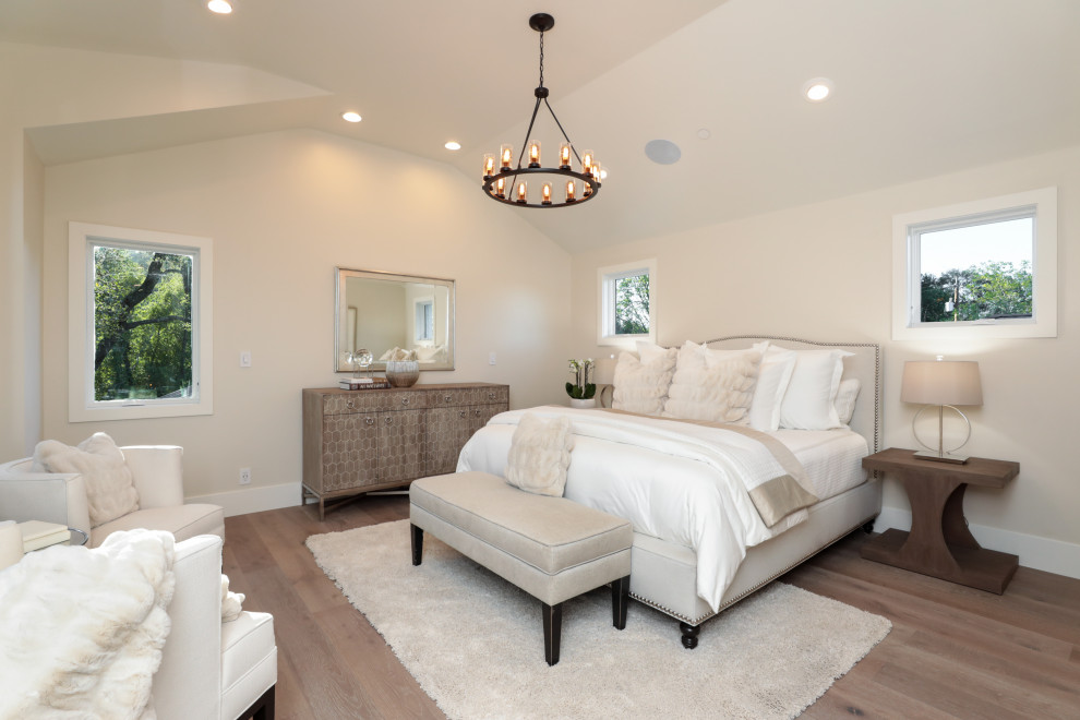 Inspiration for a transitional medium tone wood floor, brown floor and vaulted ceiling bedroom remodel in San Francisco with beige walls