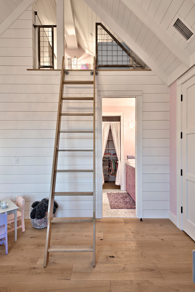 Medium sized farmhouse mezzanine bedroom in Austin with pink walls and light hardwood flooring.