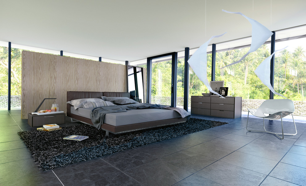 На фото: хозяйская спальня в современном стиле с черным полом без камина с