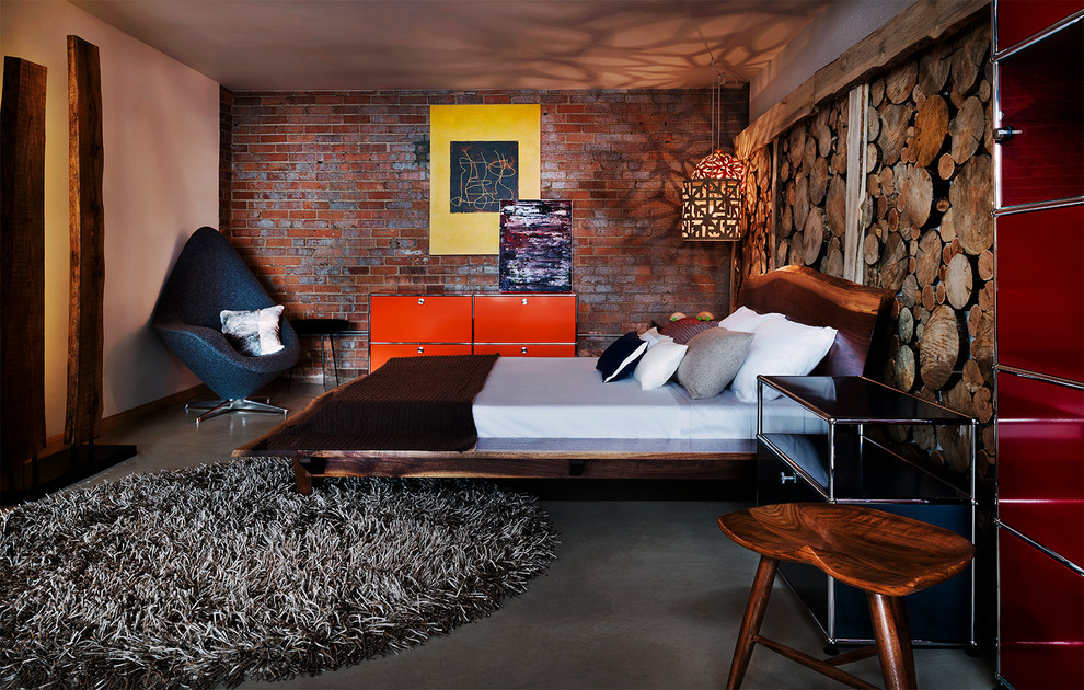 Example of an urban concrete floor bedroom design in Denver with no fireplace