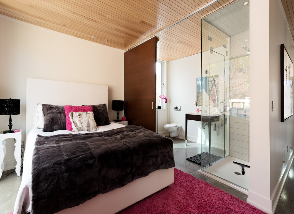 Diseño de dormitorio contemporáneo con paredes beige y suelo de cemento