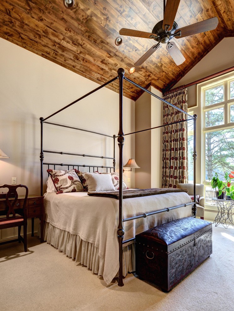 Design ideas for a rustic master bedroom in Other with beige walls and carpet.