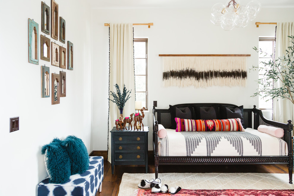 Design ideas for a large eclectic guest bedroom in San Diego with white walls, dark hardwood flooring, no fireplace and brown floors.