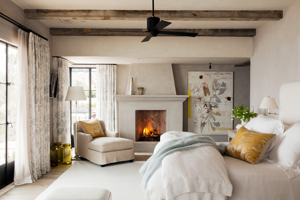 Bedroom - mediterranean master bedroom idea in Orange County with a standard fireplace