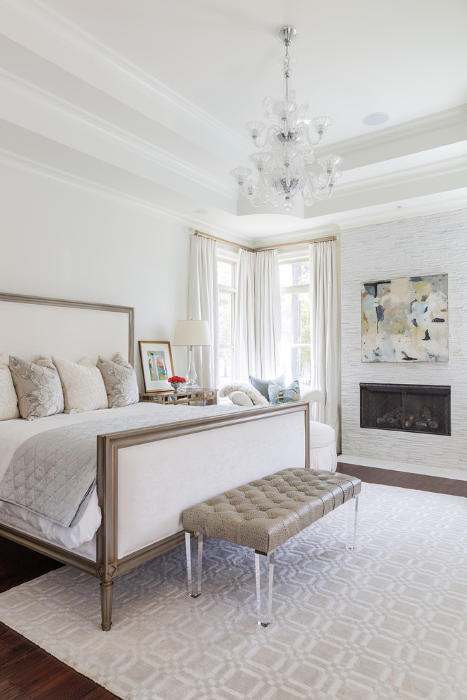 Example of a large classic master dark wood floor bedroom design in New Orleans with white walls and a ribbon fireplace