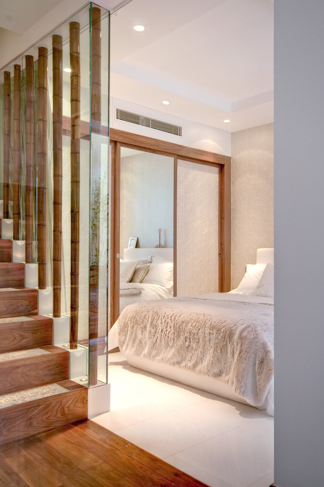 Example of a large trendy master bedroom design in London with beige walls and no fireplace