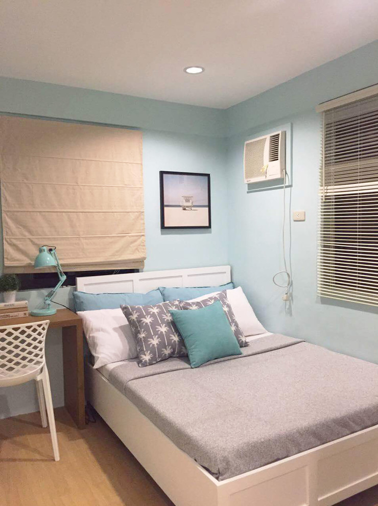 Medium sized beach style master bedroom in Other with blue walls, vinyl flooring and brown floors.