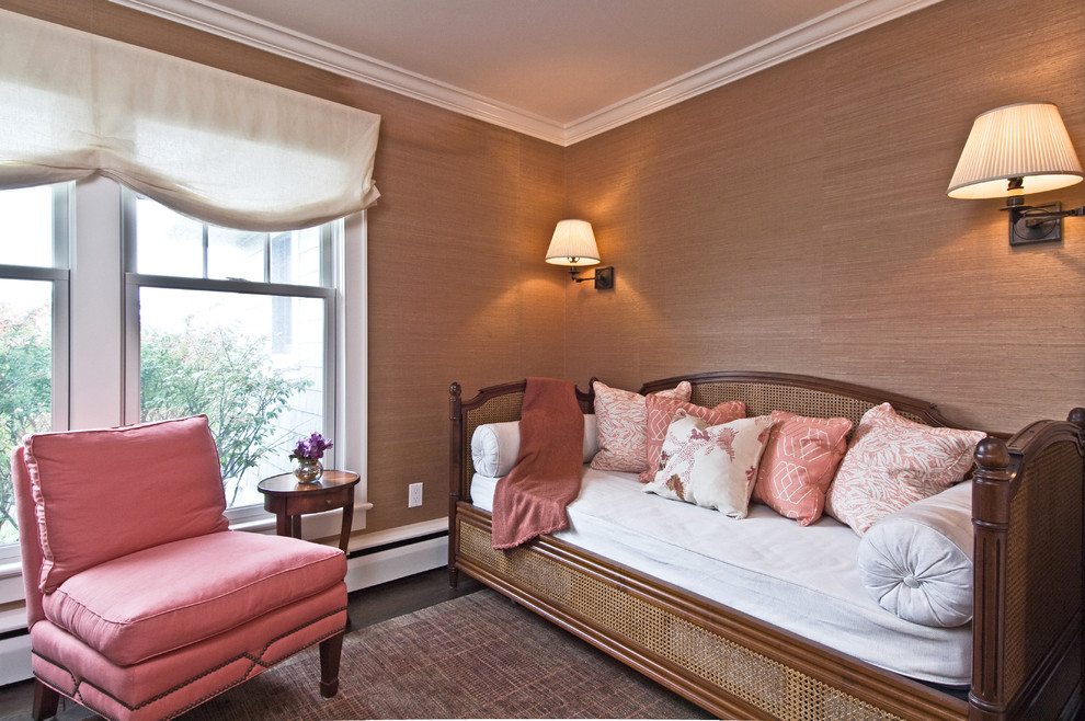 This is an example of an eclectic bedroom in New York with beige walls and dark hardwood flooring.