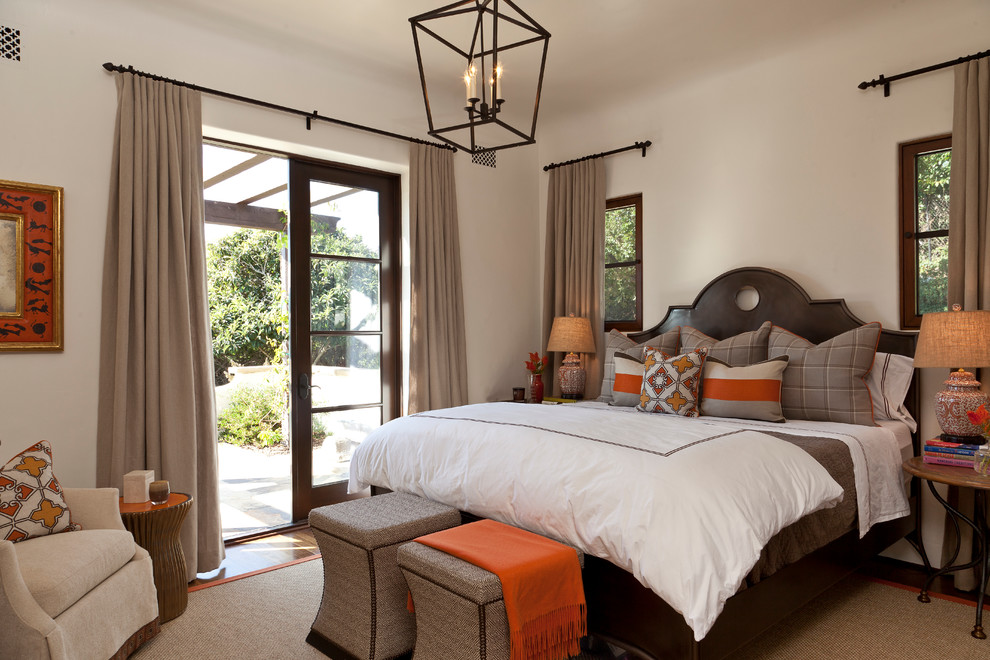 Photo of a medium sized mediterranean master bedroom in Santa Barbara with beige walls, dark hardwood flooring and no fireplace.