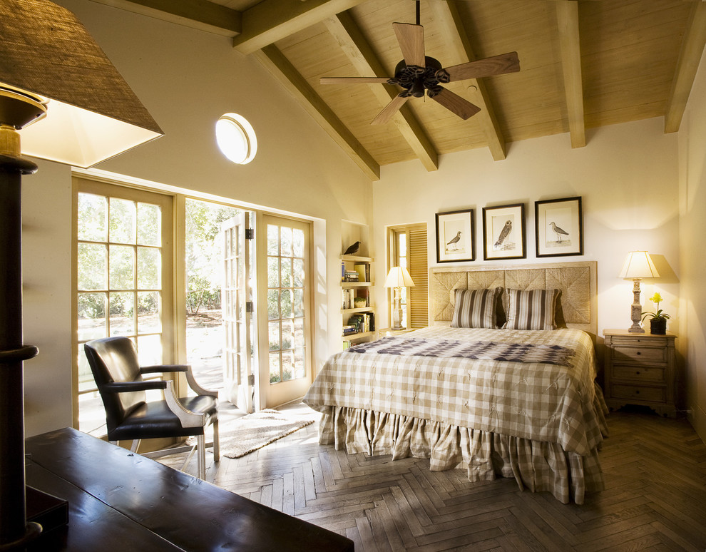 Elegant dark wood floor and brown floor bedroom photo in Santa Barbara with beige walls