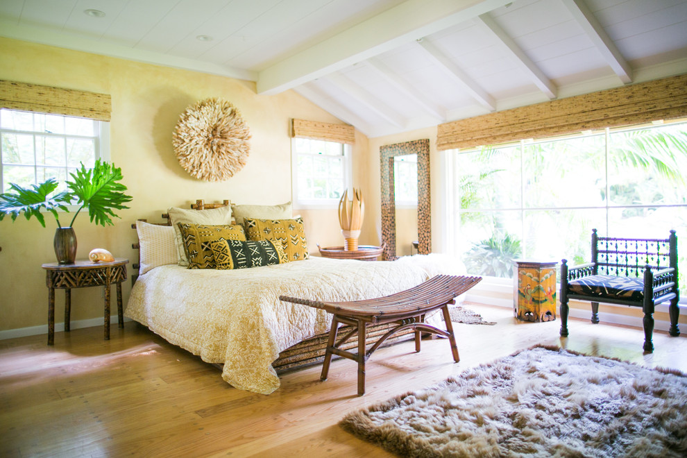 Example of a large asian master light wood floor bedroom design in Santa Barbara with beige walls