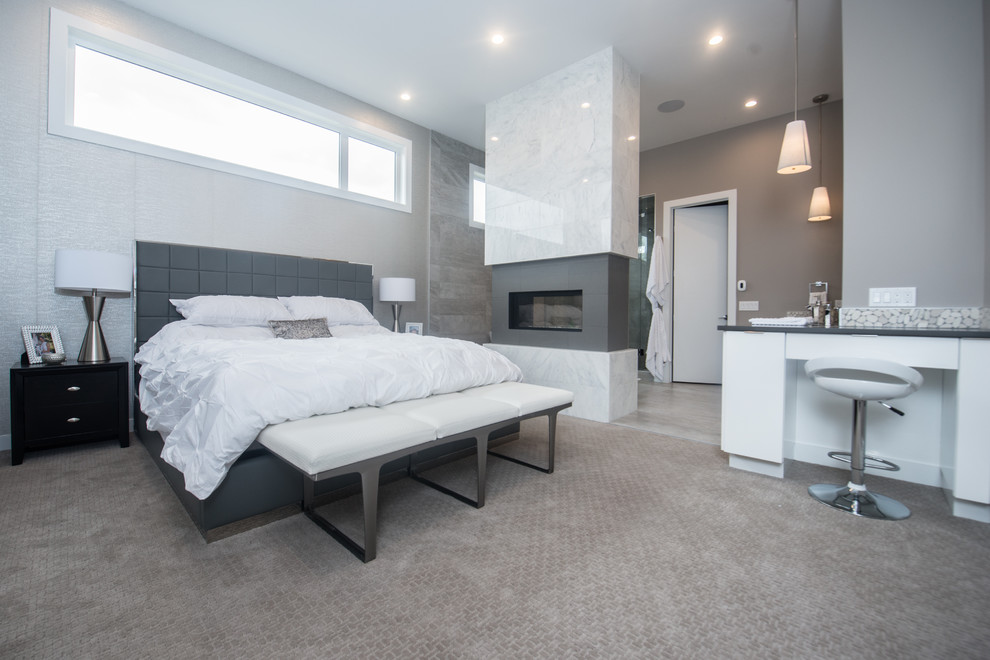 Medium sized contemporary master bedroom in Calgary with grey walls, carpet, a two-sided fireplace and a tiled fireplace surround.