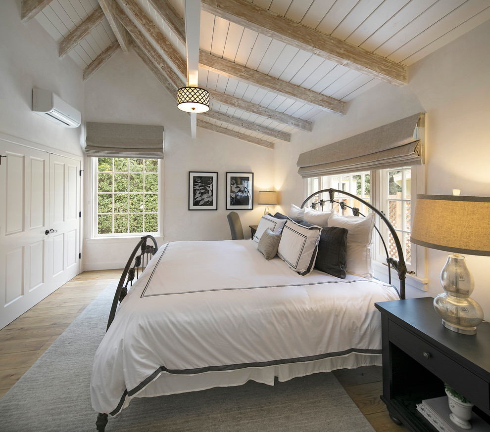 Design ideas for a small rural bedroom in Santa Barbara with light hardwood flooring.